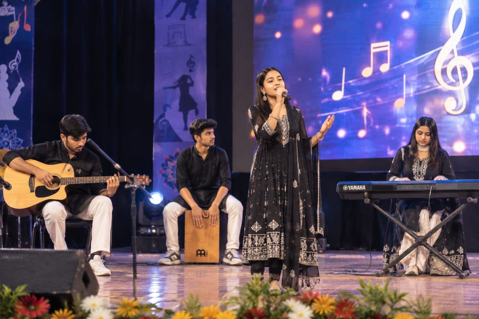 Students performing music on stage